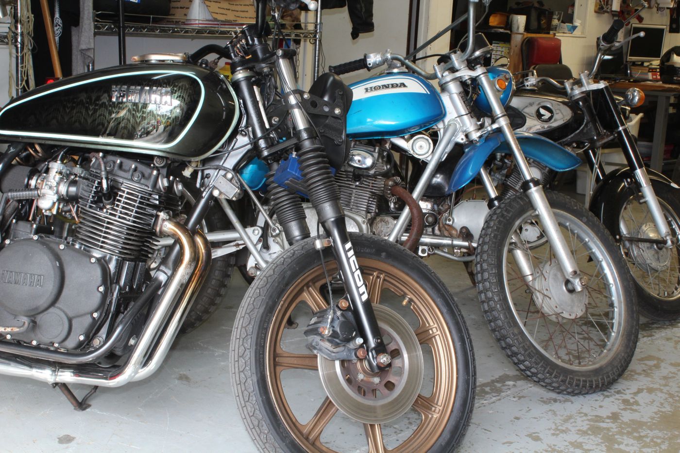 Vintage bikes in the shop, including the blue 1978 Honda SL125