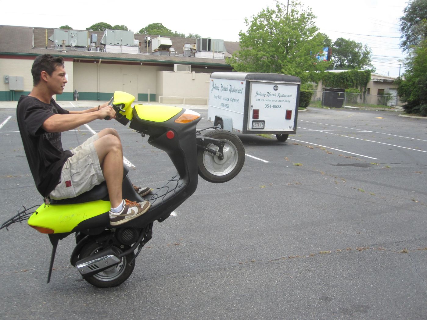 Phillip doing a wheelie on the 2-stroke Geely scooter
